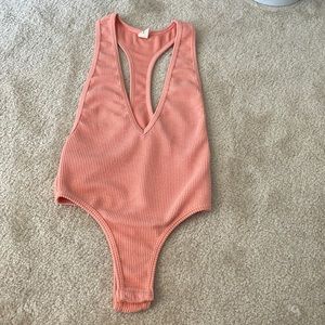 Peach colored body suit